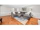 Bright living room featuring hardwood floors, a large sectional sofa, and a decorative area rug at 2502 Tritt Springs Ne Trce, Marietta, GA 30062