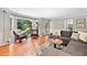 Inviting living room with bay window, hardwood floors, comfortable seating, and natural light at 2502 Tritt Springs Ne Trce, Marietta, GA 30062