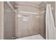 Walk-in shower showcasing gray tiling with decorative accent tiles and brushed-nickel hardware at 2502 Tritt Springs Ne Trce, Marietta, GA 30062