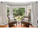 Charming sitting area featuring armchairs, hardwood floors, and a large bay window with backyard view at 2502 Tritt Springs Ne Trce, Marietta, GA 30062
