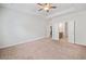 Large carpeted bedroom with adjoining bathroom and ceiling fan at 4571 Grenadine Cir, Acworth, GA 30101