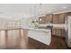 Open-concept kitchen with stainless steel appliances, granite countertops, and pendant lighting at 4571 Grenadine Cir, Acworth, GA 30101