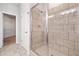 Large tiled shower with glass door and tile flooring at 4571 Grenadine Cir, Acworth, GA 30101