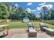 Beautiful backyard with a patio set and a green lawn with a shed in the background at 5105 Ashley Falls Ct, Loganville, GA 30052