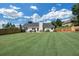 Sprawling backyard with lush lawn, patio seating, and a wooden fence for privacy and security at 5105 Ashley Falls Ct, Loganville, GA 30052