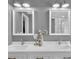 Bright bathroom featuring double sinks, white cabinets, and matching framed mirrors above each vanity at 5105 Ashley Falls Ct, Loganville, GA 30052