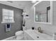 Renovated bathroom with a large vanity, modern sink, and a floating shelving above the toilet at 5105 Ashley Falls Ct, Loganville, GA 30052