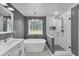 Modern bathroom features a freestanding tub, glass-enclosed shower, and elegant fixtures at 5105 Ashley Falls Ct, Loganville, GA 30052