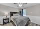Cozy bedroom with a Queen bed with gray bedding and a bedside table with lamp at 5105 Ashley Falls Ct, Loganville, GA 30052
