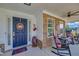 Welcoming front porch featuring patriotic decor, rocking chairs, and brick accents at 5105 Ashley Falls Ct, Loganville, GA 30052