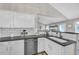 Spacious kitchen featuring white cabinetry, stainless steel appliances, and stone countertops at 5105 Ashley Falls Ct, Loganville, GA 30052