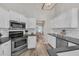 Bright kitchen featuring white cabinets, stainless steel appliances, and subway tile backsplash at 5105 Ashley Falls Ct, Loganville, GA 30052