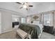 Spacious bedroom features a tray ceiling, neutral walls, and plush carpeting at 5105 Ashley Falls Ct, Loganville, GA 30052