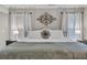 Cozy bedroom with a decorative headboard, neutral decor, and ample natural light at 5105 Ashley Falls Ct, Loganville, GA 30052