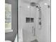 Modern glass shower with rainfall showerhead, handheld sprayer, and built-in niche at 5105 Ashley Falls Ct, Loganville, GA 30052
