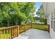 Spacious back porch with wooden railing overlooking a lush green yard at 1179 Chatham Rd, Buford, GA 30518