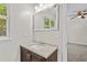 Bright bathroom features a granite countertop, modern faucet, and large mirror at 1179 Chatham Rd, Buford, GA 30518