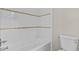 White tiled tub and toilet, complemented by a decorative tile border at 1179 Chatham Rd, Buford, GA 30518