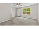 This bedroom has carpet flooring, a ceiling fan, and an exterior door with a view of the deck at 1179 Chatham Rd, Buford, GA 30518