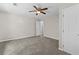 Neutral bedroom featuring gray carpet, ceiling fan, and white doors at 1179 Chatham Rd, Buford, GA 30518