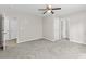 A neutral bedroom features carpet flooring and multiple access doors to hallways and closets at 1179 Chatham Rd, Buford, GA 30518