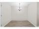 A simple dining room has neutral walls, plank flooring, and traditional light fixture at 1179 Chatham Rd, Buford, GA 30518