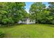 This cozy home showcases a spacious, well-kept yard perfect for outdoor enjoyment, blending seamlessly with nature's beauty at 1179 Chatham Rd, Buford, GA 30518