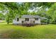 Charming home featuring a well-maintained lawn, inviting entryway, and a classic carport offering a welcoming curb appeal at 1179 Chatham Rd, Buford, GA 30518