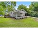 Inviting home with a covered front porch and landscaped greenery, showcasing a peaceful outdoor setting, and a side carport at 1179 Chatham Rd, Buford, GA 30518