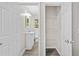 Hallway view of the full bathroom and shelved closet at 1179 Chatham Rd, Buford, GA 30518