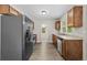 The kitchen features stainless appliances, wood cabinets, and granite counters, combining functionality with a contemporary design at 1179 Chatham Rd, Buford, GA 30518