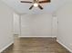 An empty living room with wood-look flooring and multiple hallways leading to other rooms at 1179 Chatham Rd, Buford, GA 30518