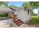 Rear entrance to a bright home with a covered parking area and wooden steps at 1179 Chatham Rd, Buford, GA 30518