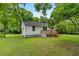 White home with a backyard, green lawn, and a quaint wooden deck at 1179 Chatham Rd, Buford, GA 30518