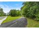 Scenic view of the property from the street with a long driveway at 1179 Chatham Rd, Buford, GA 30518