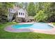 A beautiful backyard featuring a large inground pool, a spacious deck, and lush greenery at 4341 Horder Ct, Snellville, GA 30039