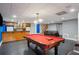 Finished basement with a pool table, bar area, and comfortable leather sofa at 4341 Horder Ct, Snellville, GA 30039