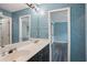 Bathroom features a dual sink vanity with a large mirror, paint grade cabinets and modern fixtures at 4341 Horder Ct, Snellville, GA 30039
