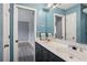 Bathroom features a dual sink vanity, paint grade cabinets, updated fixtures, and large mirror at 4341 Horder Ct, Snellville, GA 30039