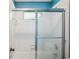 Updated bathroom with a shower-tub featuring white tile and a modern glass door enclosure at 4341 Horder Ct, Snellville, GA 30039
