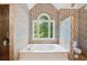 Luxurious bathroom with jetted tub, shower, and beautiful wallpaper at 4341 Horder Ct, Snellville, GA 30039