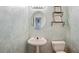 Charming powder room with pedestal sink and decorative wallpaper at 4341 Horder Ct, Snellville, GA 30039