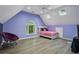 Bedroom features wood floors, a ceiling fan, skylights, and a bed with pink sheets at 4341 Horder Ct, Snellville, GA 30039