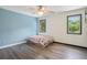 Bedroom features wood floors, a ceiling fan, and two windows with nice natural light at 4341 Horder Ct, Snellville, GA 30039