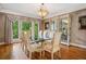 Elegant dining room featuring a glass table, hardwood floors, and serene views from the expansive window at 4341 Horder Ct, Snellville, GA 30039