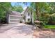 Charming home with stone accents, an attached garage, and well-maintained landscaping in a serene, wooded setting at 4341 Horder Ct, Snellville, GA 30039