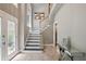 Elegant foyer featuring a staircase, decorative console table, and tiled floors that create a welcoming entrance at 4341 Horder Ct, Snellville, GA 30039