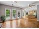 Bright living area flows into kitchen, featuring hardwood floors, large windows, and access to outdoor deck at 4341 Horder Ct, Snellville, GA 30039