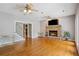 Cozy living room with stone fireplace, hardwood floors, and natural light at 4341 Horder Ct, Snellville, GA 30039
