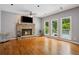 Inviting living room boasts a stone fireplace, hardwood floors, and large windows with natural light at 4341 Horder Ct, Snellville, GA 30039